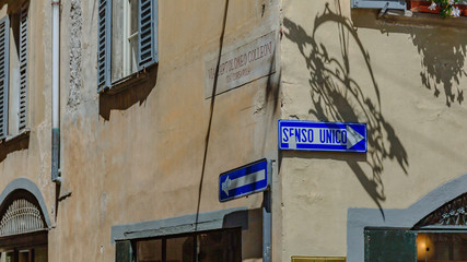 Street signs on old buildings in Bergamo, Italy