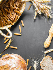 Pasta and bread with wholemeal flour and rustic background