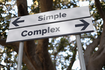 "Simple or complex" decision crossrroads sign with opposite direction arrows. Life decision concept.