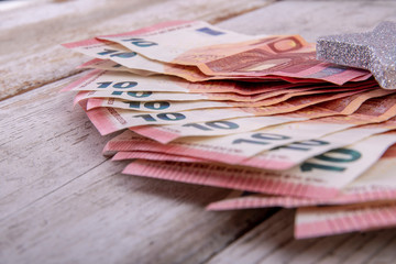 a lot of ten euro bills on white rustic wood