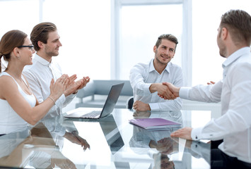 handshake business partners over the Desk
