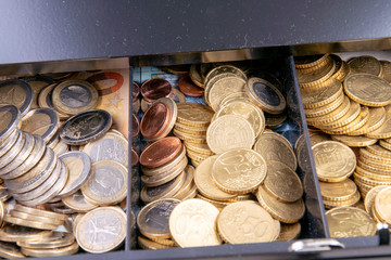 Cash box with coins and banknotes in Euro