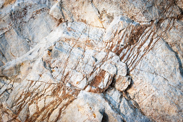 brown veins of quartz on white limestone