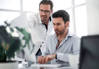 business colleagues discussing business issues near the desktop