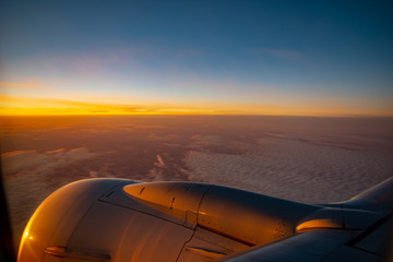Obraz na płótnie Canvas Sunrise from an airplane, Flying into a new day