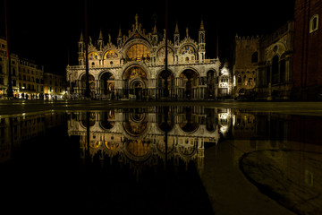 Fototapeta na wymiar The reflection of San Marco Basilica in the flooded Piazza San Marco in Venice