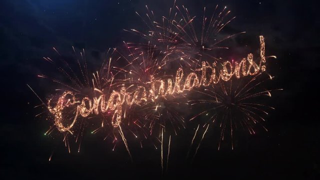 Congratulations greeting text with particles and sparks on black night sky with colored slow motion fireworks on background, beautiful typography magic design.
