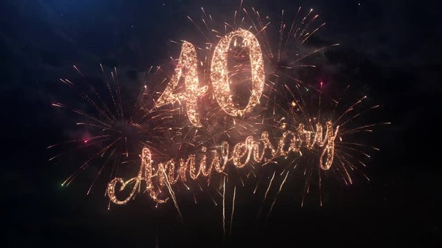 Happy birthday Anniversary 40 years celebration greeting text with particles and sparks on black night sky with colored slow motion fireworks on background, beautiful typography magic design.