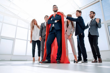 boss is a superhero and the business team is standing together © ASDF