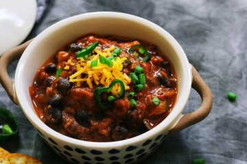 Homemade Beef Chili topped with Cheddar cheese and green onions