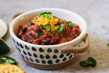Homemade Black beans Beef Chili topped with cheddar cheese and green onions