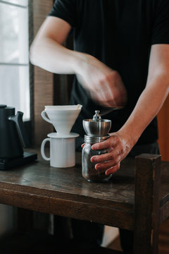Hand grinding coffee beans.