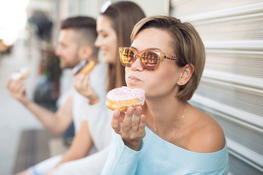 Beautiful woman eating a donut