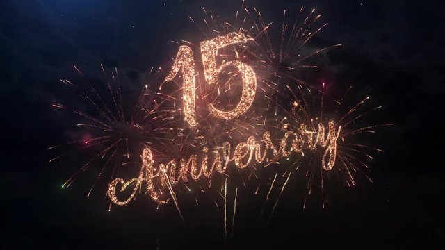 Happy birthday Anniversary 15 years celebration greeting text with particles and sparks on black night sky with colored slow motion fireworks on background, beautiful typography magic design.