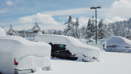 Very snowy parking lot with cars covered in snow for background plate