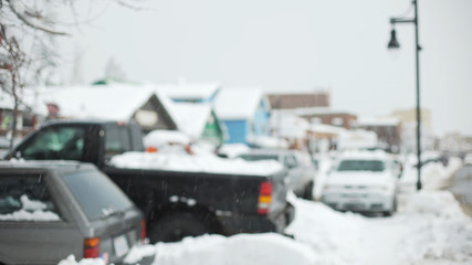 Snow covered cars in a suburban parking lot for background plate