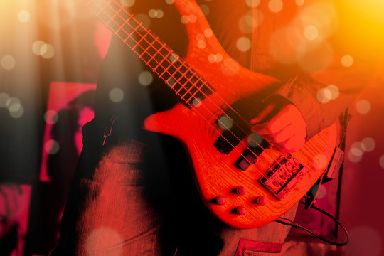 Life style image of close up young man hand, playing electric bass guitar
