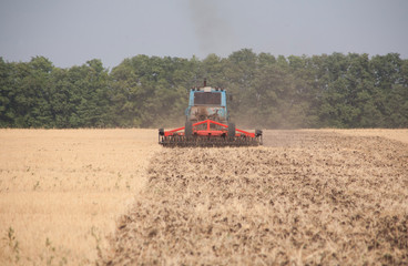 Fototapeta premium Tractor preparing land for sowing