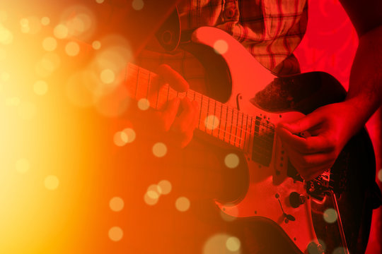 Life style image of close up young male guitarist hand, playing electric guitar