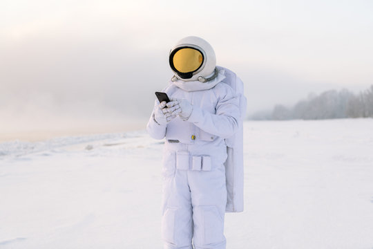 Astronaut standing with smartphone