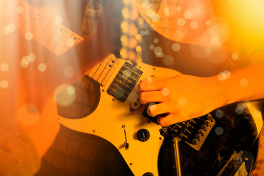 Life style image of close up young male guitarist hand, playing electric guitar