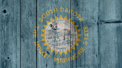 USA Politics News Concept: US State South Dakota Flag Wooden Fence