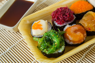 Sushi rolls served on a wooden plate