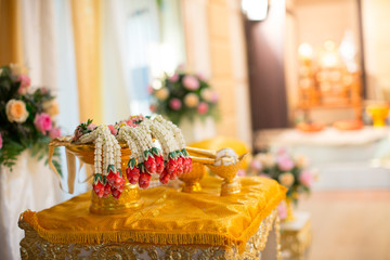 Thai wedding accessory for cultural wedding ceremony, luxury chair for bride and groom, golden tray with pedestal and the others. image for wedding objects, copy space and advertisement.