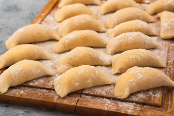 Homemade dumplings with filling, prepared for cooking.
