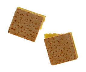 Top view of two freshly baked lemon squares isolated on a white background.
