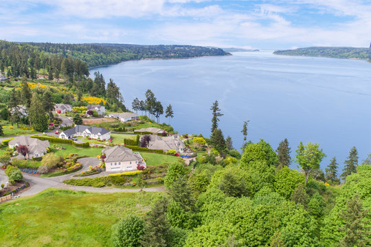 Aerial drone view of luxury waterfront residential houses overlooking a bay
