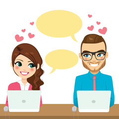 Couple flirting while working with laptop over desk
