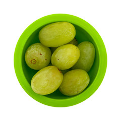 Top view of a serving of green grapes in a small bowl isolated on a white background.