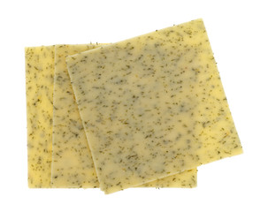 Top view of three slices of garlic cheddar cheese isolated on a white background.