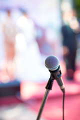 microphone in concert hall or conference room soft and blur style for background.Microphone over the Abstract blurred photo of conference hall or seminar room background.