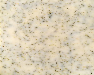 Top close view of a garlic cheddar cheese slice.