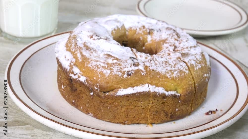 Poster slicing a cranberry bundt cake