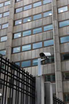 Camera on fence with building on background