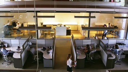 Elevated view of staff working in a busy open plan office