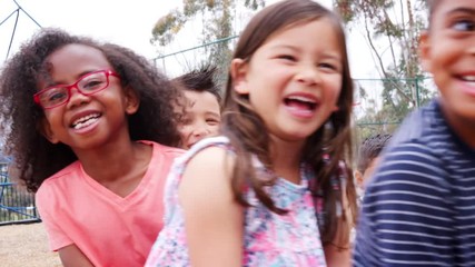 Elementary school kids spinning in a playground - Powered by Adobe