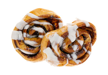 Overhead view of  two warm freshly baked cinnamon rolls isolated on a white background.