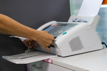 Hand man are using a fax machine in the office, Business concept office life