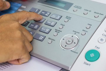 Hand man are using a fax machine in the office, Business concept office life