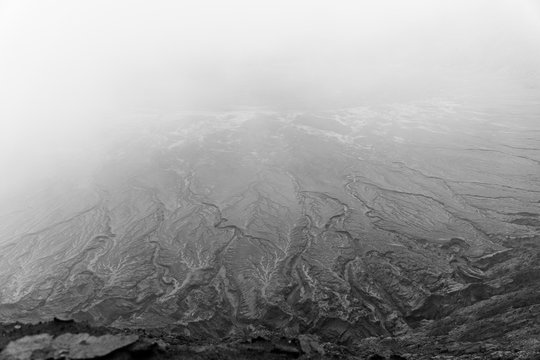 Black and white image of a foggy floodplain