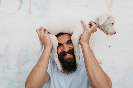 Portrait Of Young Man With Beard And His Little Dog