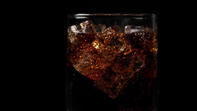 Pouring coca cola into the glass
