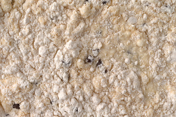 Top view of clumpy chocolate chip muffin mix with milk added.