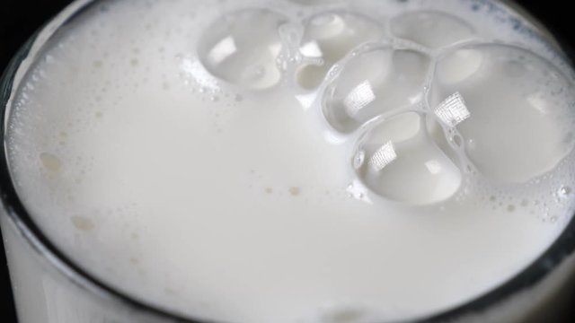Bubbles in milk in the glass