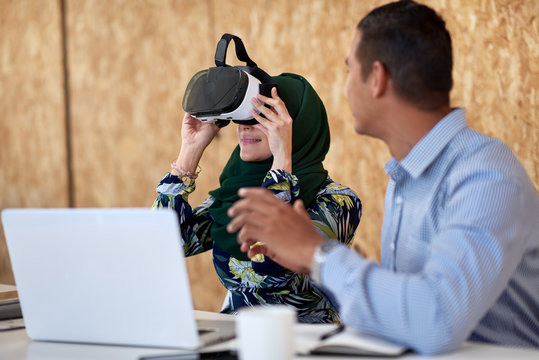 Muslim woman using virtual reality headset
