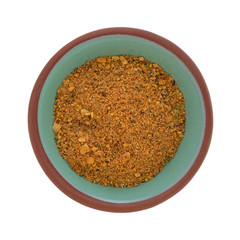 Top view of a bowl filled with a dry brown sugar and molasses marinade mix isolated on a white background.